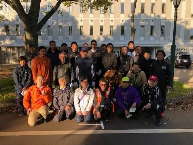 A group of course measurers posing outdoors after a seminar.