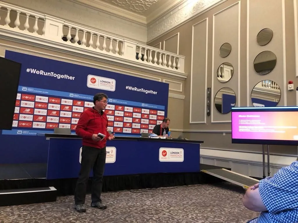 An official speaking at a press conference podium.